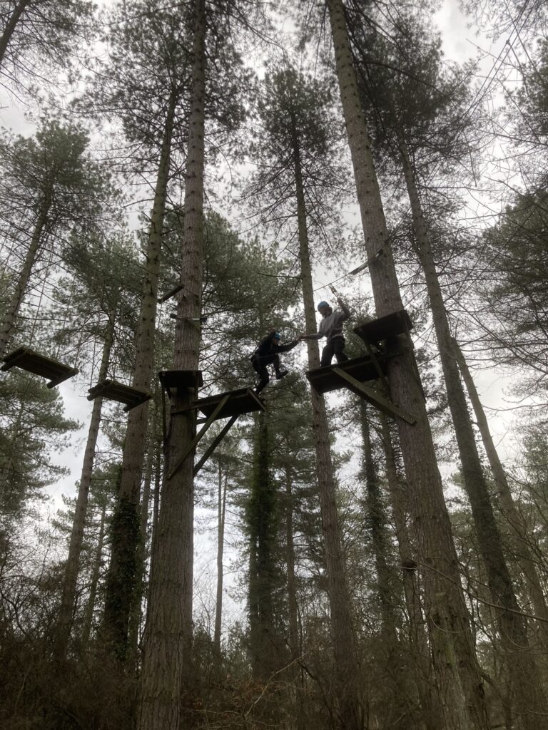 Two people on a high ropes course